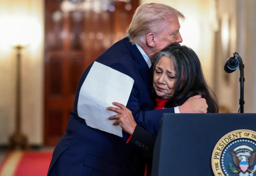 President Donald Trump hugs Marie Vega, mother of a Border Patrol Agent killed by a person in the country illegally, at a White House event for 