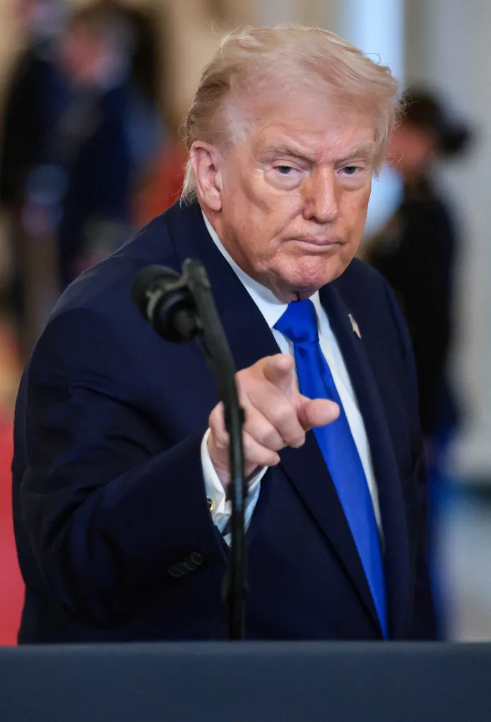 Donald Trump gesturing and pointing at an event at the White House.