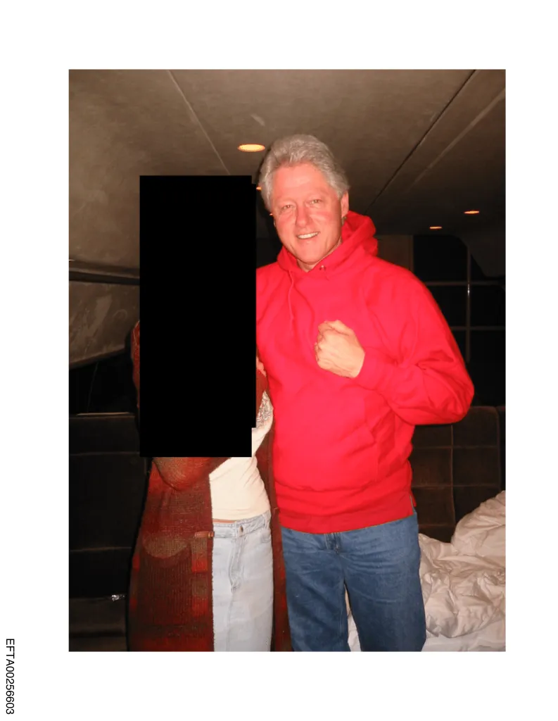 Photo of former President Bill Clinton in a red hoodie and jeans with an unidentified person whose body is mostly redacted.