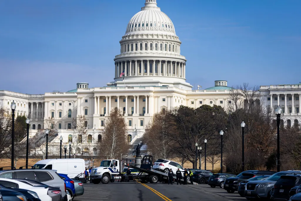 Tow truck removing a car near the US Capitol building where a man was arrested with a gun.
