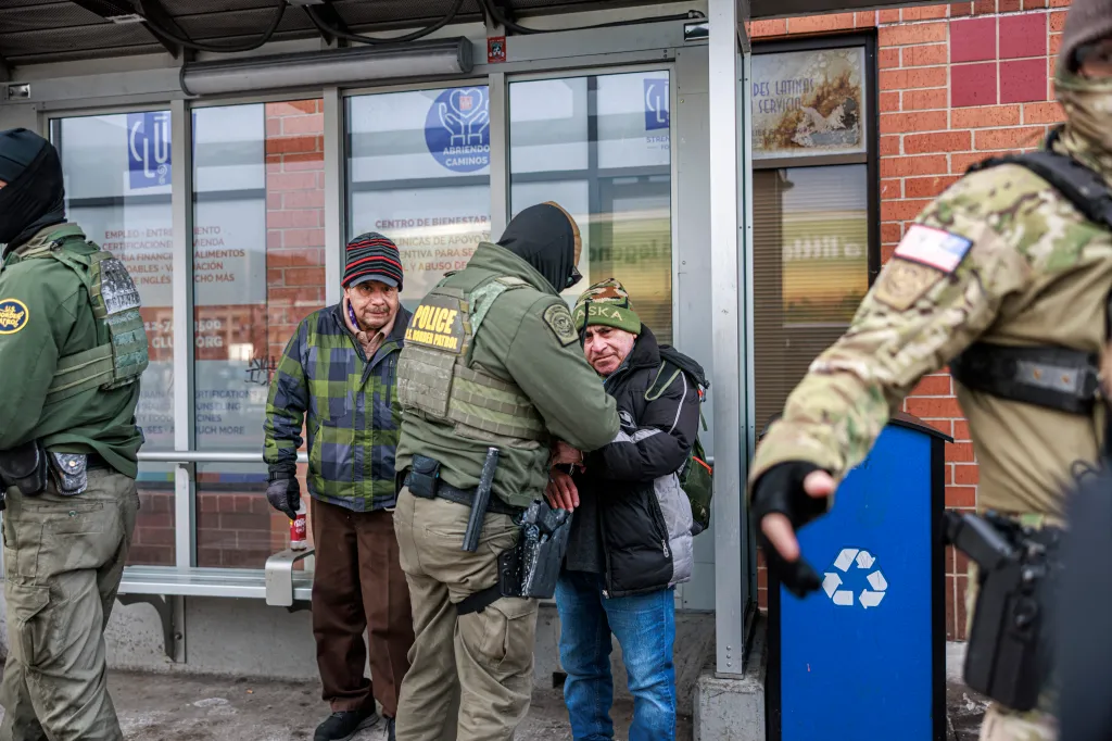 A U.S. Border Patrol agent arresting a man in front of a community center.