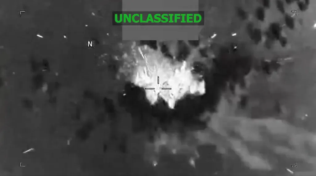 Thermal image showing an explosion with a targeting crosshair in the center.