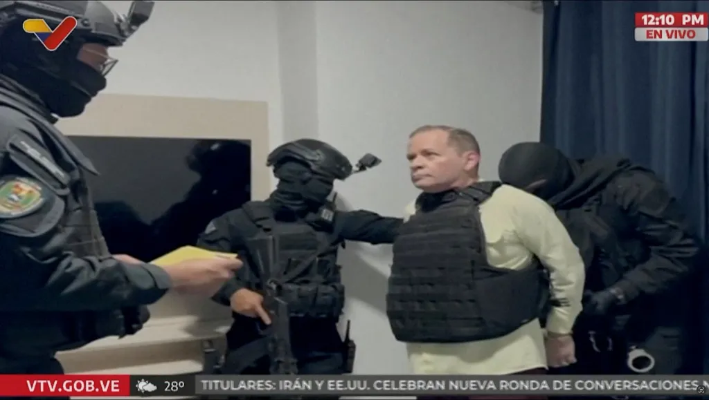 Venezuela opposition politician Juan Pablo Guanipa is handcuffed by law enforcement officers.