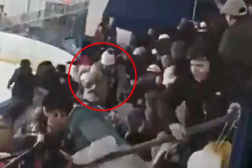 Roberta Esposito (also known as Robert Dorgan), circled in red, among a crowd at a hockey game.