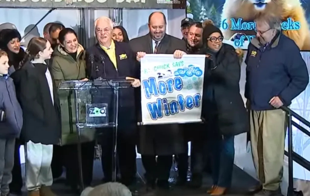 People displaying a banner that reads 