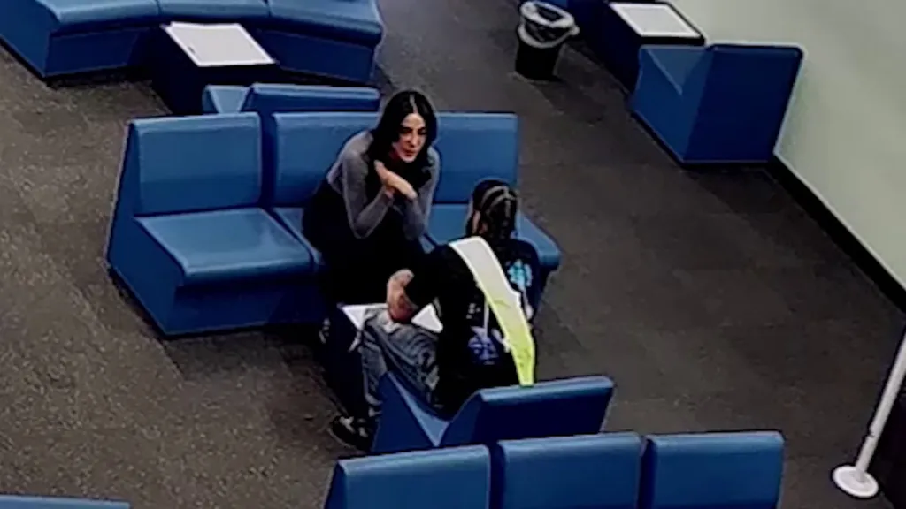 A probation officer leaning in to kiss a convicted murderer during a prison visit.