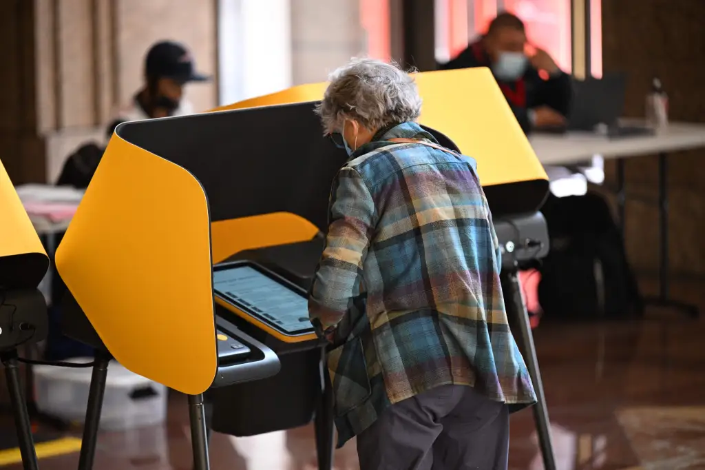 A voter prepares their ballot at a voting booth during early voting ahead of the US midterm elections.