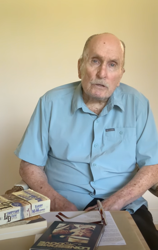 Robert Duvall speaking, with copies of 