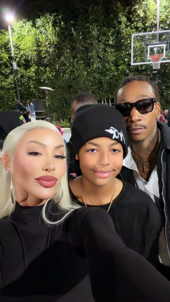 Amber Rose, her son Sebastian, and Wiz Khalifa posing for a photo.