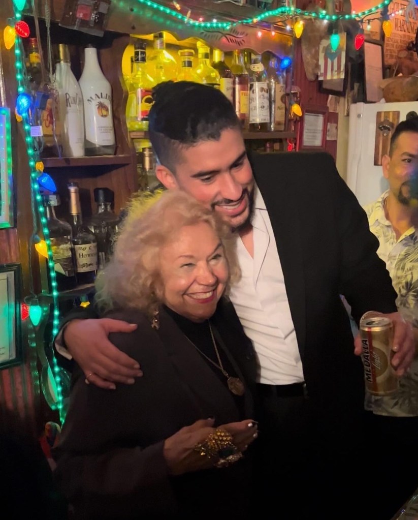 Bad Bunny embracing an older woman at the release party for his new album 