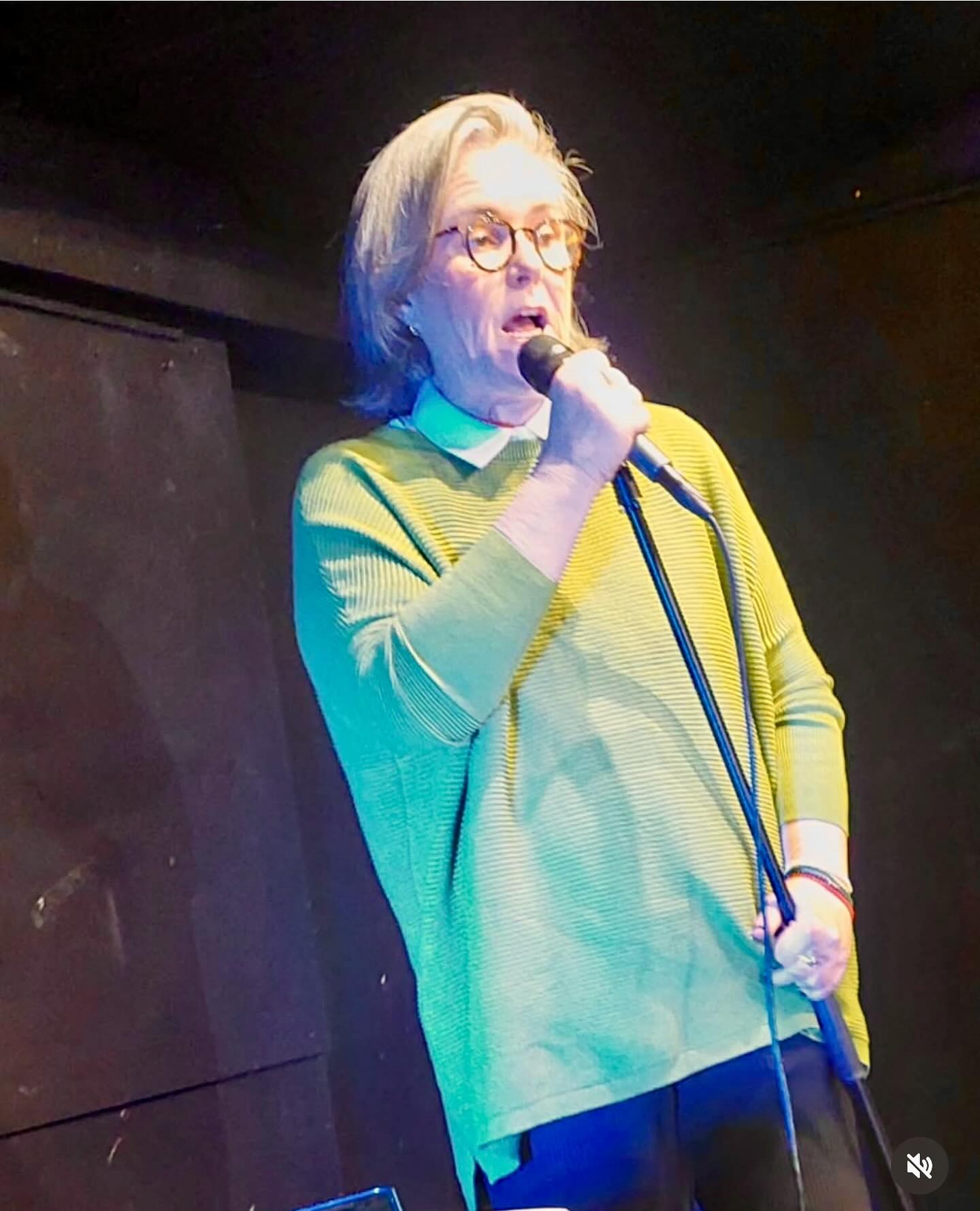 Rosie O'Donnell speaking into a microphone.