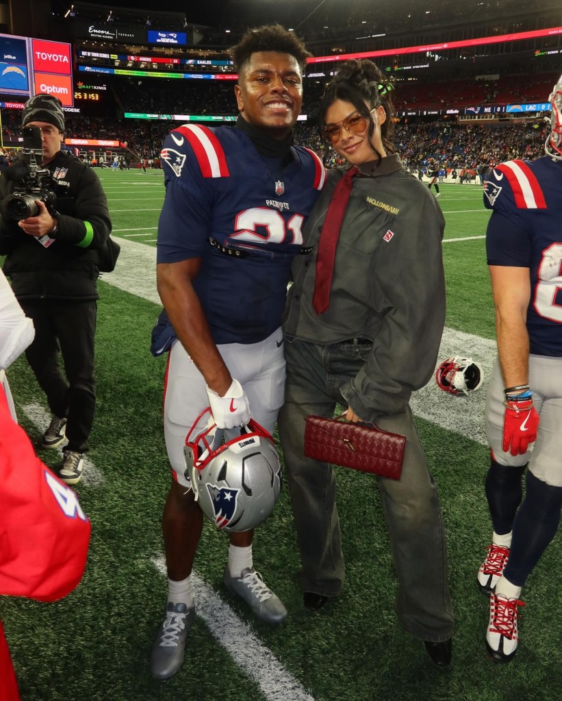 Jayda and Jaylinn Hawkins posing on a football field.