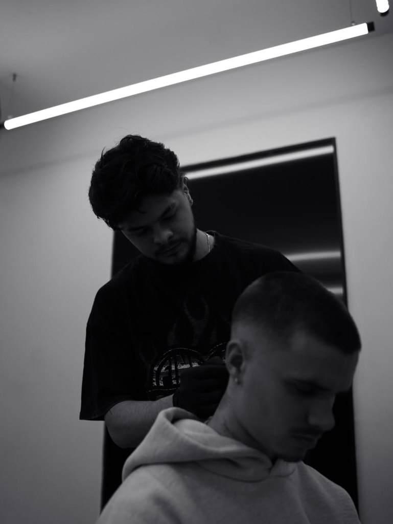 Romeo Beckham getting a tattoo on his neck.