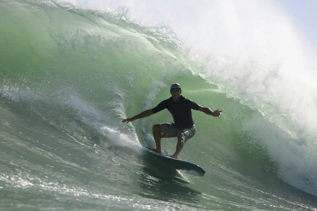 Kurt Van Dyke surfing on a green wave.