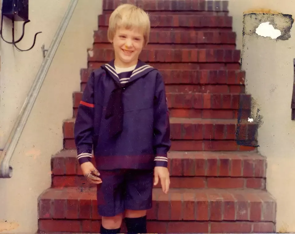 Young Gavin Newsom smiling in a sailor suit.