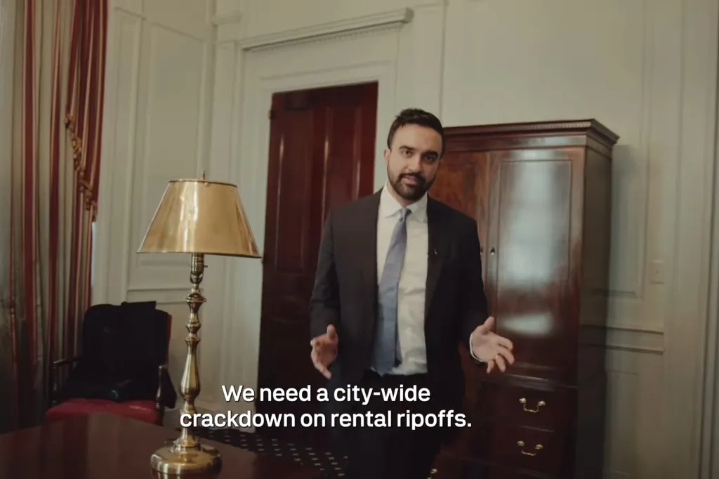 Zohran Mamdani in a suit, speaking about upcoming 'Rental Ripoff' hearings.
