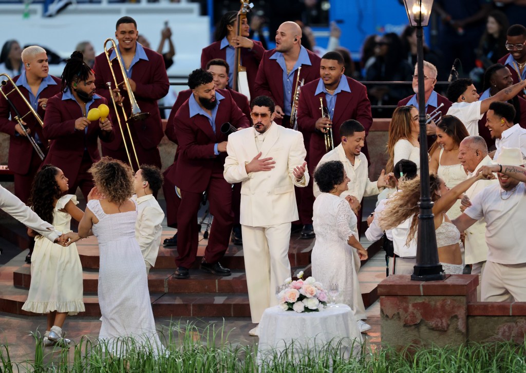 Bad Bunny performs during the Super Bowl halftime show with a band and dancers.