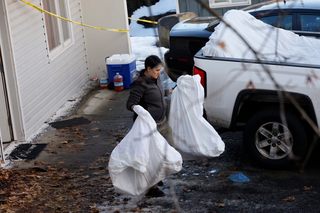 Law enforcement agents remove bedding and blood-stained mattresses from the off-campus home on Jan. 6, 2023.
