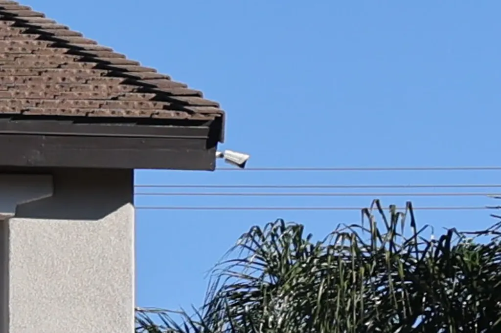 Security camera visible on the corner of a house.