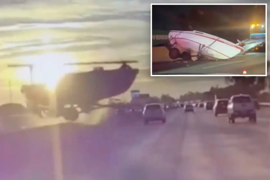 Terrifying moment runaway boat careens across traffic on major LA freeway