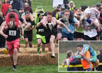 Finnish pair wins a barrel of ale in annual ‘wife-carrying’ contest in England
