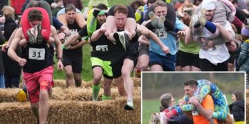 Finnish pair wins a barrel of ale in annual ‘wife-carrying’ contest in England