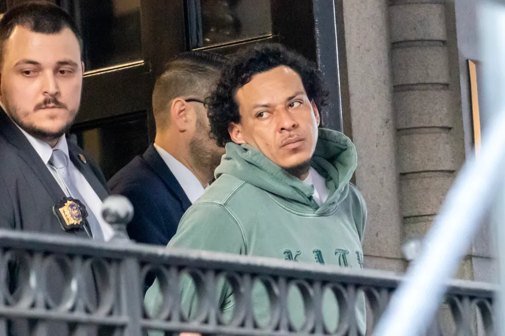 Bairon Hernandez being escorted by detectives after his arrest.