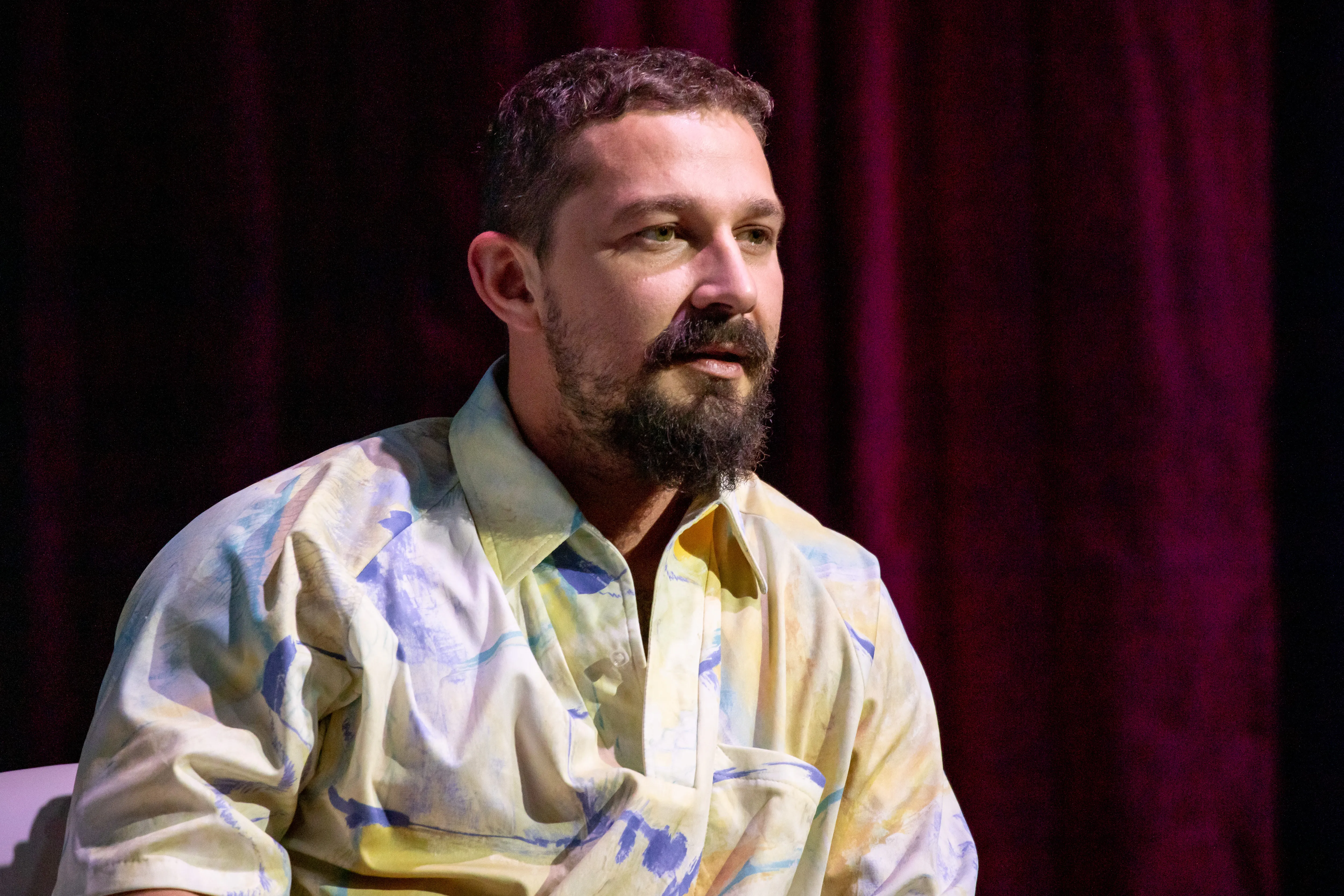 Actor Shia LaBeouf wearing a colorful patterned shirt.