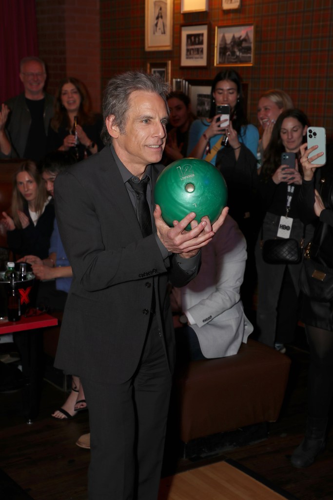Ben Stiller holding a green bowling ball at the premiere of