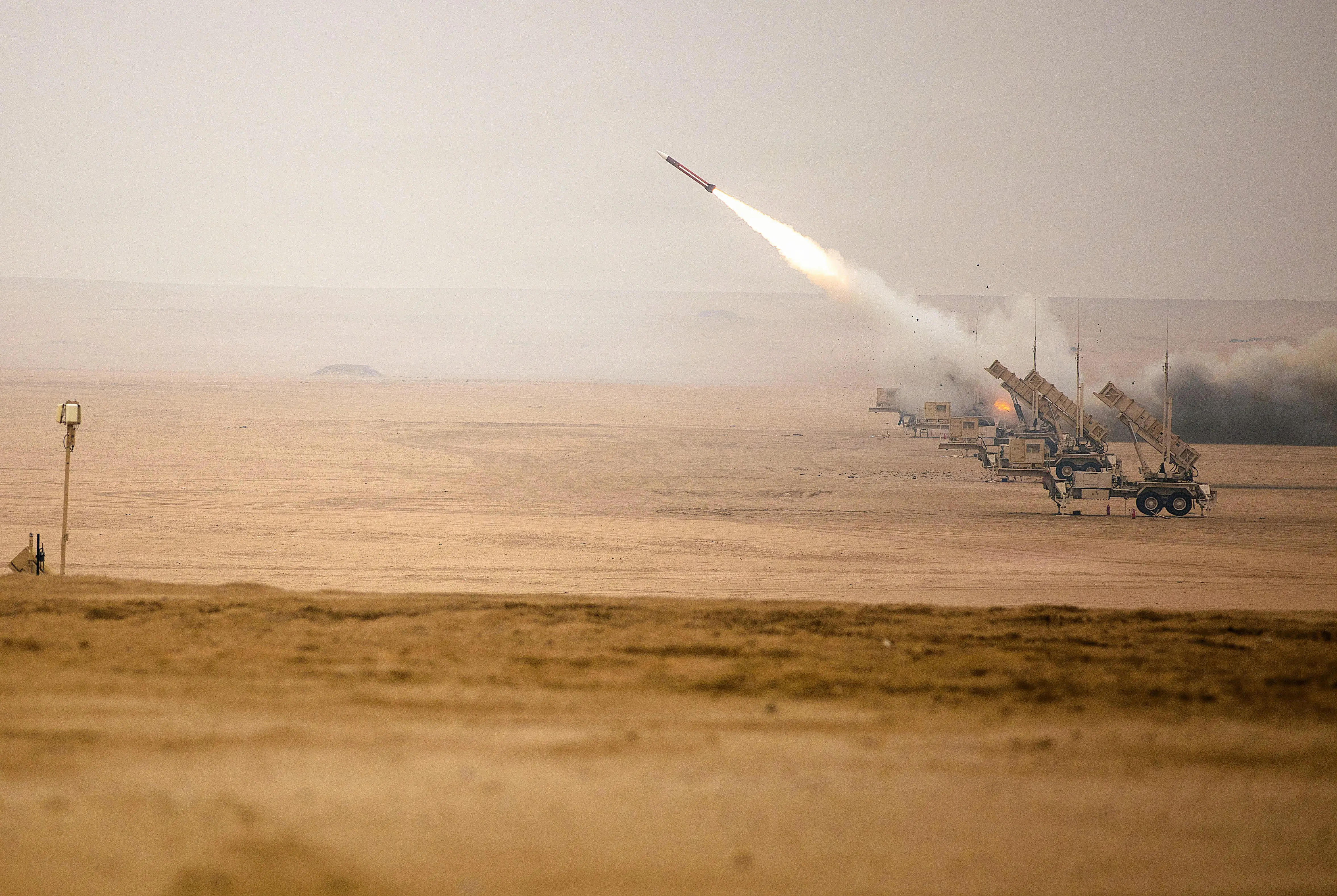 A missile is fired from a launcher in a desert.