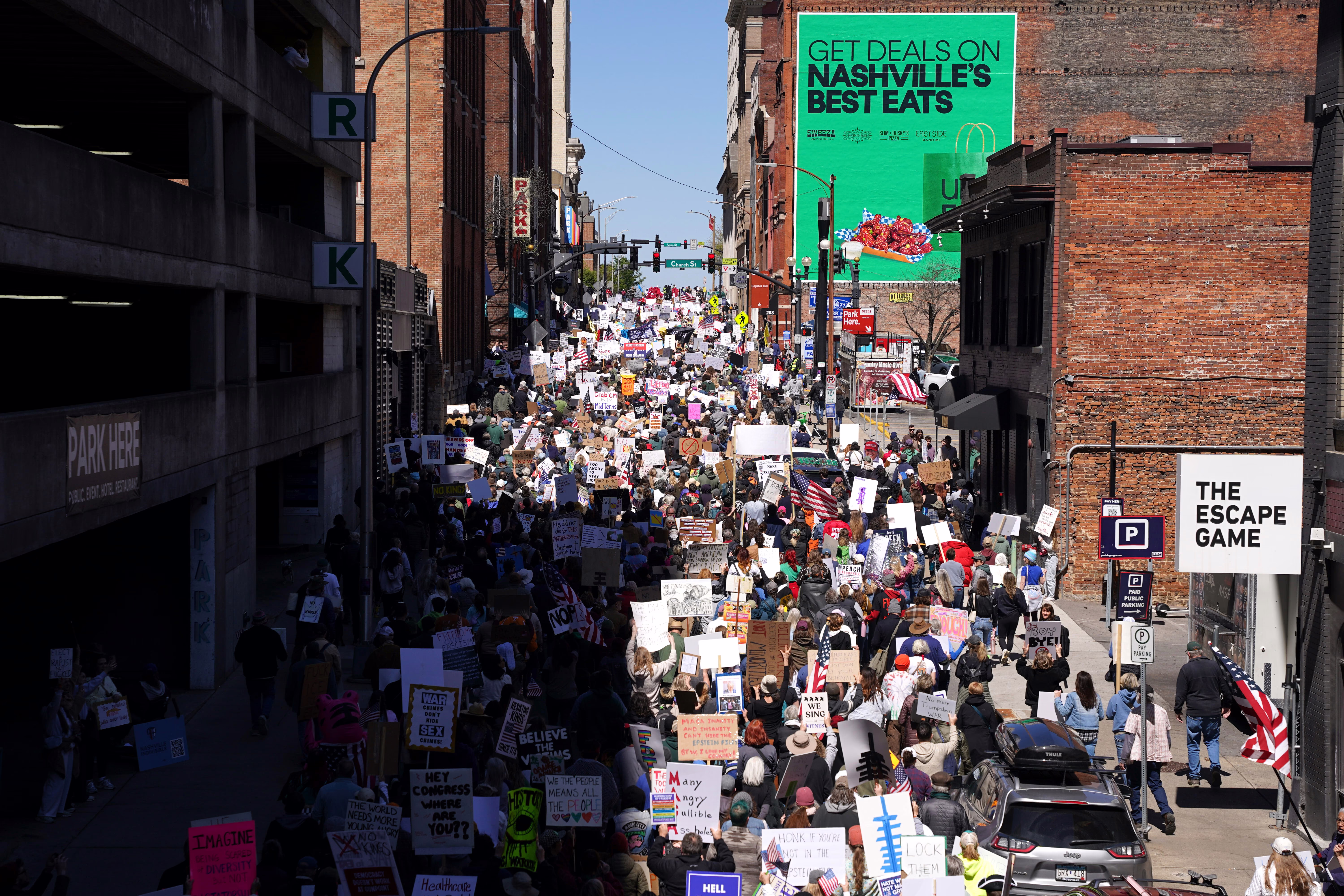 Thousands of protesters marched down a street in downtown Nashville.