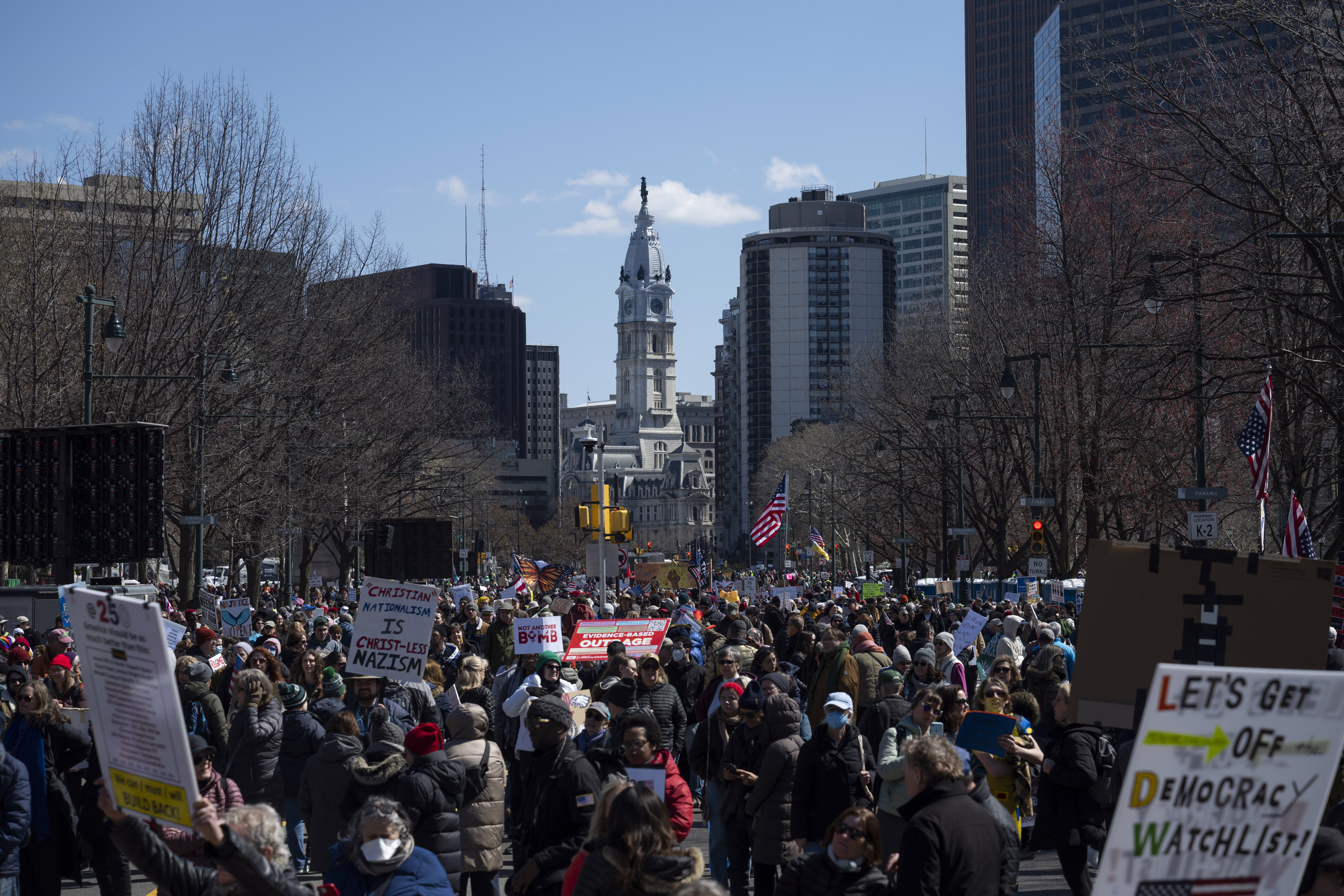Protesters march down a city street in Philadelphia.