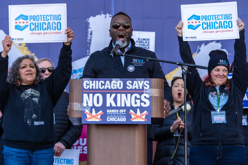 Chicago Mayor Brandon Johnson speaks at a podium with a 