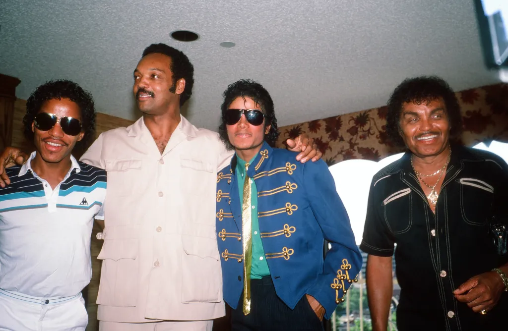 Jesse Jackson (second left) stands with Marlon Jackson (left), Michael Jackson (second right), and Joe Jackson (right).