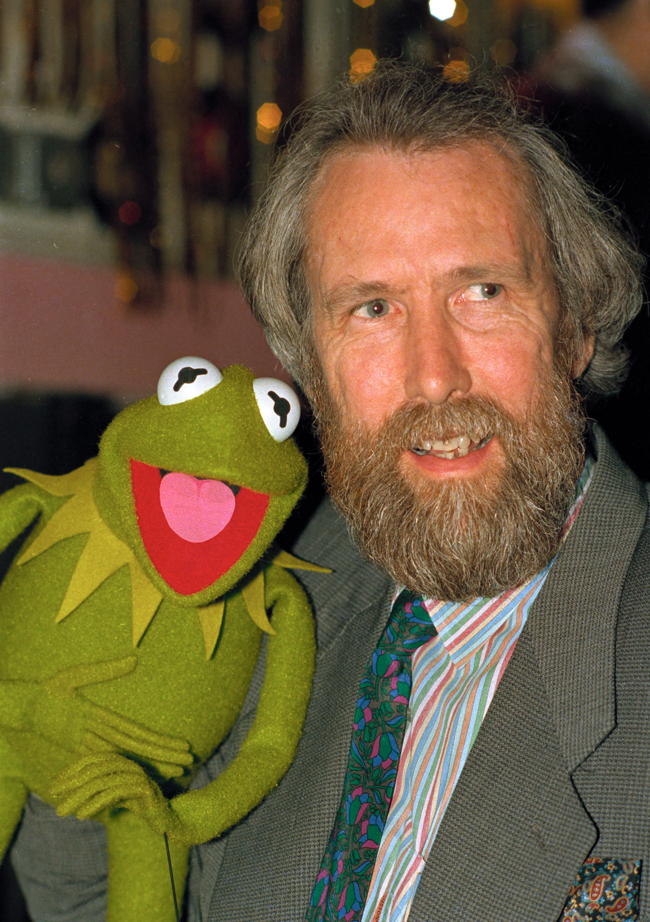 Henson poses with Kermit the Frog.