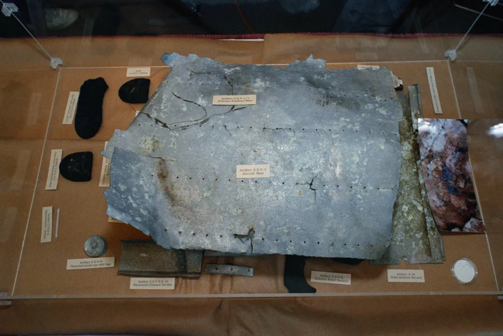 Amelia Earhart artifacts including aircraft skin and shoe heels.