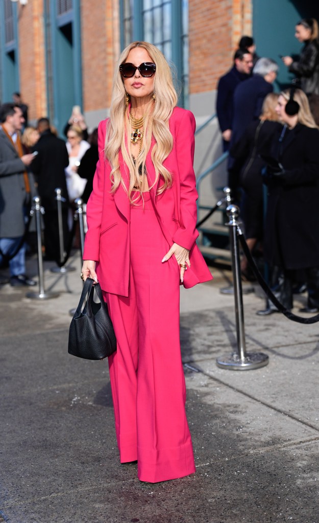 Rachel Zoe wearing a hot pink pantsuit at the Carolina Herrera show during New York Fashion Week.