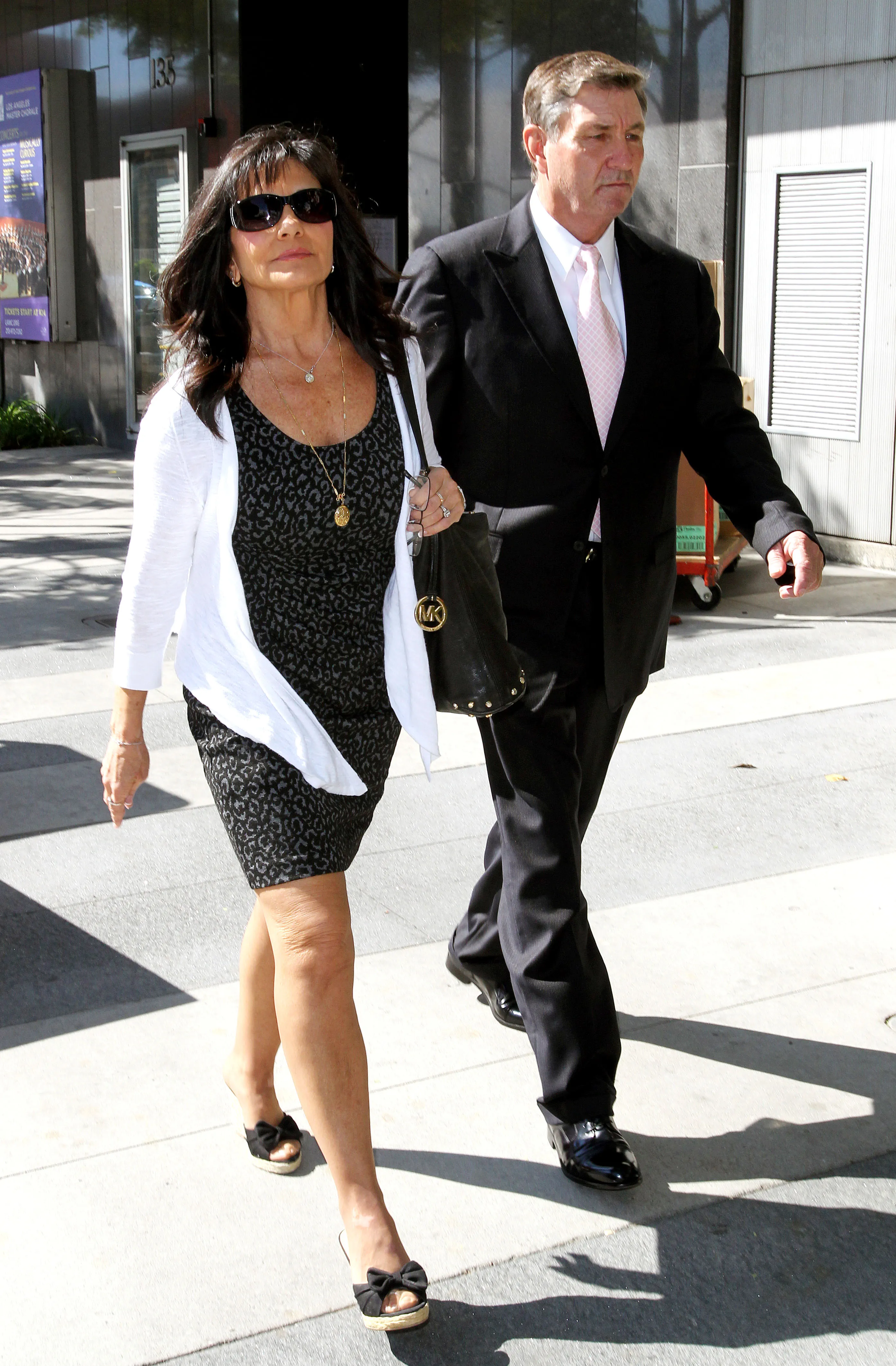 Jamie Spears walking with Lynne Spears outside a courthouse.