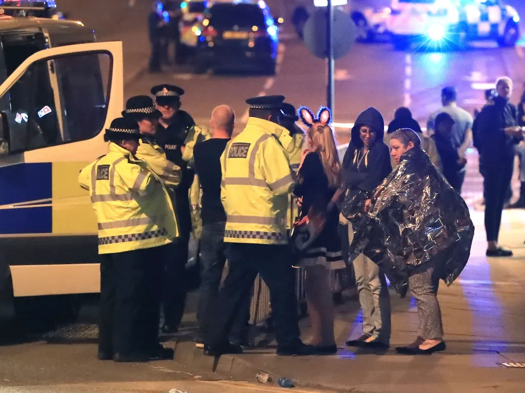 Emergency services and concert-goers at Manchester Arena after an explosion.