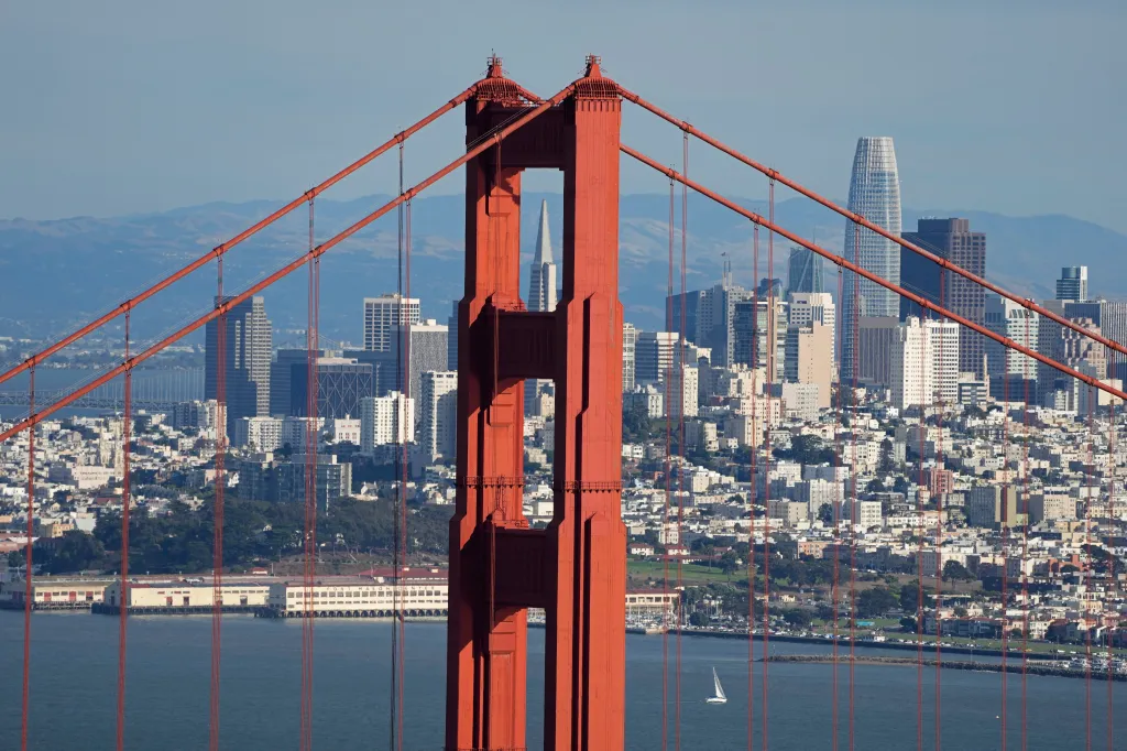The Golden Gate Bridge in the foreground with the San Francisco skyline in the background.