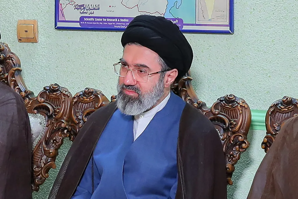 Mojtaba Khamenei, son of Iran's slain supreme leader, wearing a black turban and glasses, looking right.