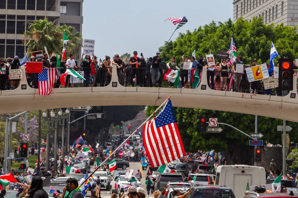 Demonstrators protest against the Trump administration on a bridge and street in Los Angeles, California.
