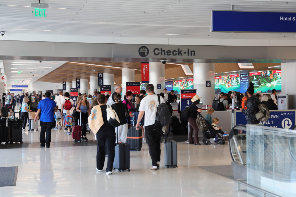 Passengers at Los Angeles International Airport, with a 