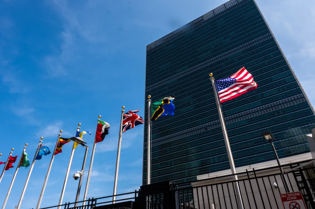 Flags of various nations, including the US, flying outside the United Nations headquarters in New York City.