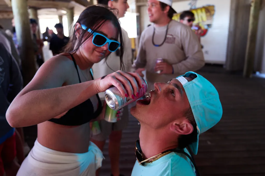 Spring breakers drink alcohol during a concert at Harpoon Harry's Beachfront Restaurant on Thursday, March 20, 2025 in Panama City Beach, Fla.