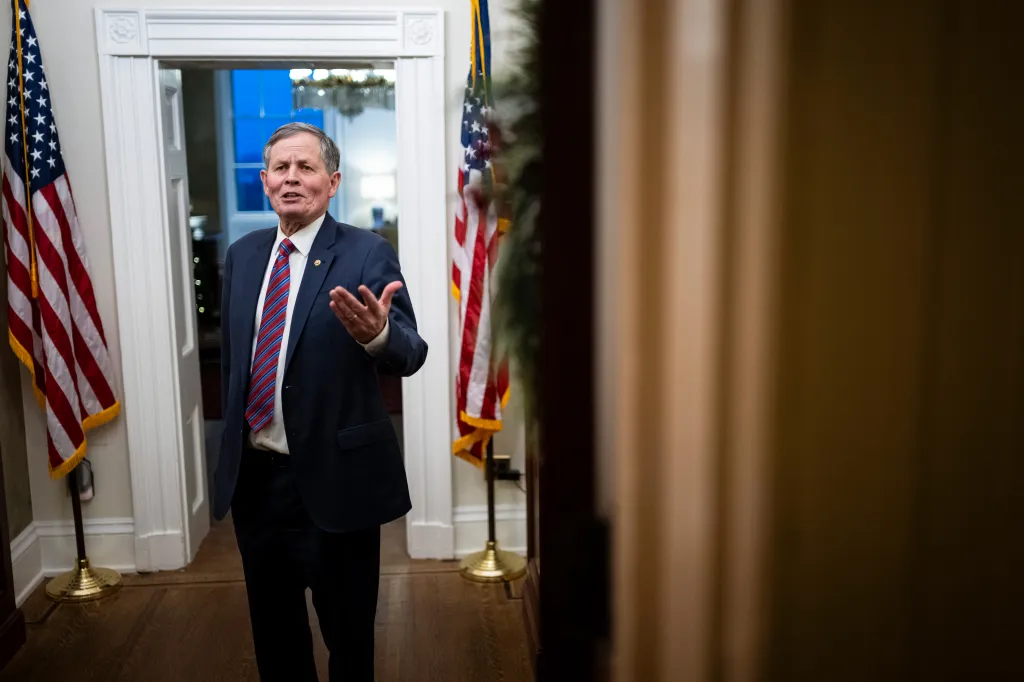 Senator Steve Daines speaking at the US Capitol, gesturing with his hand.
