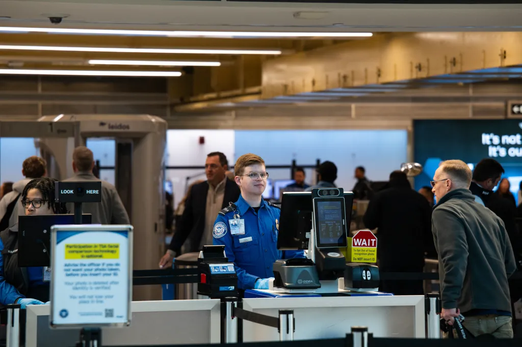 TSA agents assisting travelers at Ronald Reagan Washington National Airport.