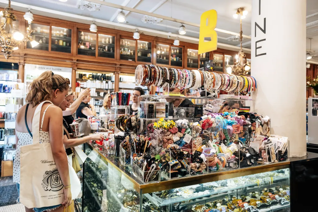 Customers browsing hair accessories in a store with 