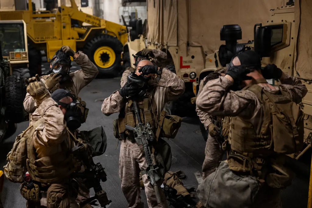 U.S. Marines don M50 joint service general purpose masks during training aboard USS Boxer.