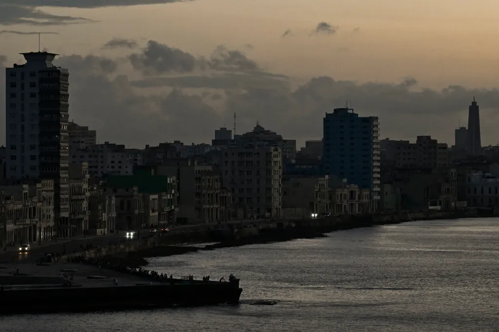 This view shows buildings at sunset during a blackout in Havana on March 16, 2026. Cuba suffered a widespread power cut on March 16, 2026, according to the national electricity company, against the backdrop of a severe crisis on the island caused by the US energy blockade. (Photo by Yamil LAGE / AFP via Getty Images)